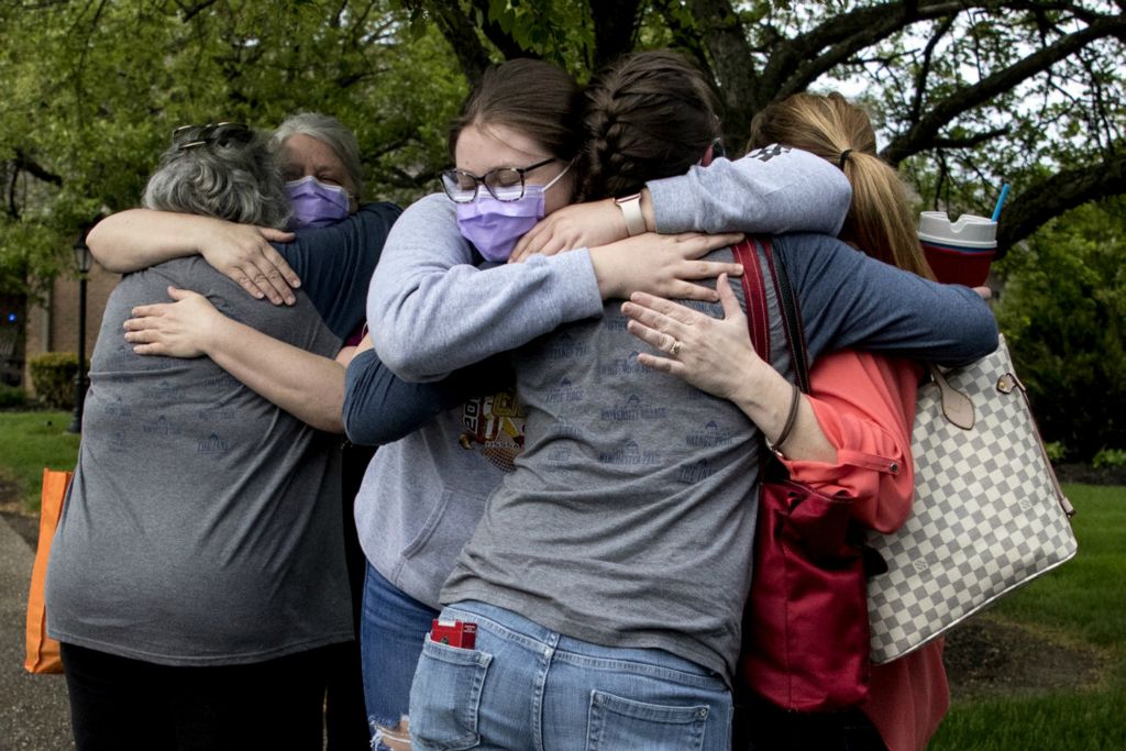 Third Place, Feature Picture Story - Jessica Phelps / Newark Advocate, “Nurses Go On Lockdown With Residents”Staff from SharonBrooke hug each other and family members before heading home May 15, after 65 days of living in the assisted living facility. The staffs of SharonBrooke and Chapel Grove banded together and decided to make the sacrifice of staying away from their families and living with residents to protect them from the coronavirus. As staff left they were greeted by loud cheers from supporters as well as firetrucks and police cars.